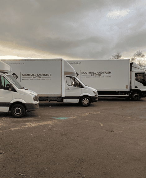 Southall and Rush branded delivery trucks parked outdoors under cloudy sky.